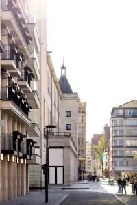 a city street with buildings and a cross on a building at Hotel Montaigne in Ostend +16 photos