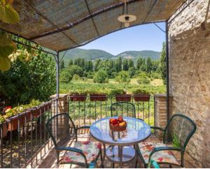 a table with a bowl of fruit on a balcony at Agriturismo I Melograni in Ferentillo