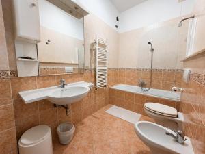 a bathroom with two sinks and a toilet and a tub at Hotel Cristallo - Chianciano Terme in Chianciano Terme +18 photos
