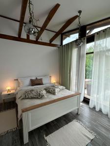 a bedroom with a bed and a large window at Mon Resort by Ana1St in Scărişoara +56 photos