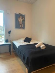 a bedroom with a bed and a picture of a woman at Tuukkaq Apartments in Nuuk