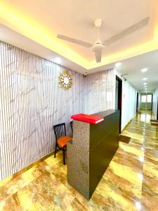 a lobby with a red counter and a chair at Hotel Vasundhara Villa - Greater Kailash in New Delhi