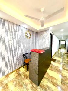 a lobby with a red counter and a chair at Hotel Vasundhara Villa - Greater Kailash in New Delhi