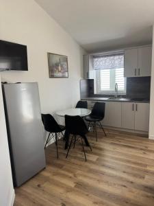 a kitchen and dining room with a table and chairs at House 100m from the beach with free parking in Baška Voda