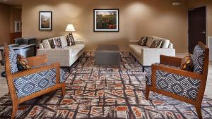 a living room with two couches and a rug at Best Western Plus Elmendorf Hotel San Antonio Hotel in Elmendorf +6 photos