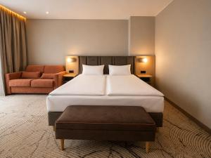 a hotel room with a bed and a couch at Tower Hotel Wrocław in Wrocław +24 photos