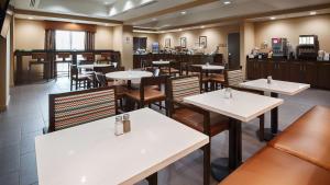 a dining room with tables and chairs in a restaurant at Best Western Plus Elmendorf Hotel in Elmendorf