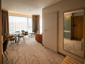 a room with a mirror and a table and chairs at Tower Hotel Wrocław in Wrocław