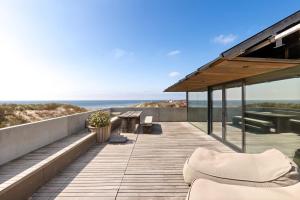 a wooden deck with a view of the ocean at Duinhotel Tien Torens in Zoutelande