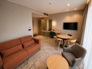 a living room with a couch and a table at Tower Hotel Wrocław in Wrocław
