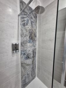 a shower in a bathroom with a stone wall at B&B Monviso in Casavecchie +41 photos