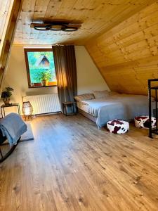 a bedroom with a bed and a large window at Green-in in Jaklovce