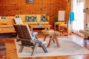 a living room with a chair and a table at Tranquil Hillhouse in Nkoanrua