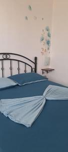 a bed with a blue comforter on it with at Relax tra mare e monti Flumini di Quartu in Santa Luria