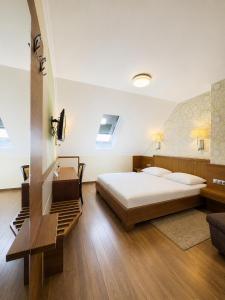 a bedroom with a large bed and a staircase at Mizse Motel in Lajosmizse