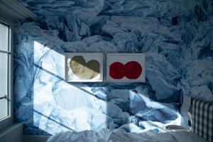 a bedroom with two hearts on the wall at Boutique & Art Hotel Helvetia in Zurich