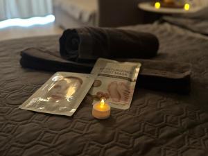 a book and a candle on a bed at Gemütliche Ferienwohnung mit Blick auf die Donau in Obernzell