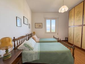 a bedroom with a bed and a desk and a window at La Casa dell'Anello - Relax & View - ItalyWeGo in Narni