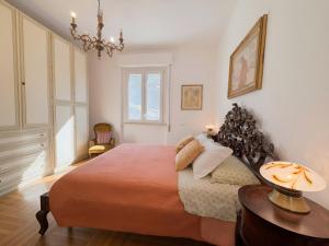a bedroom with a large bed and a chandelier at La Casa dell'Anello - Relax & View - ItalyWeGo in Narni