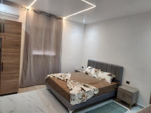 a bedroom with a bed in a white room at Villa jenni in Temlale