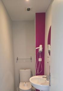 a bathroom with a toilet and a sink at The Originals City, Hôtel Le Savoy, Caen in Caen +24 photos