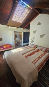 a bedroom with a large bed in a room at Finca Cueva del Viento in Icod de los Vinos