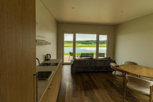 a kitchen with a table and a view of the water at 313 apartments in Užpelkiai