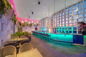a hotel lobby with a pool and a bar at Wink Tuy Hoa Beach, Unscripted by Hyatt - 24 Hours stay in Tuy Hoa