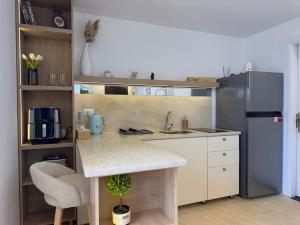 a kitchen with a counter and a refrigerator at Smart Home near beach and pool in Sharm El Sheikh