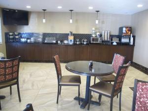 a dining room with a table and chairs and a counter at Best Western Woodland Inn in Woodland