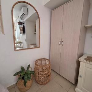 a bathroom with a mirror and a potted plant at כרמונ'ס פטיו - Carmona's Patio in Eilat