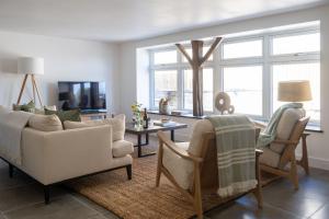 a living room with a couch and chairs and a table at The Store in Salcombe