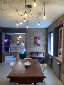 a living room with a wooden table and a ping pongetitive at Loft - Villa Flore apartments in villa in Casteldaccia