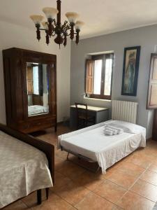 a bedroom with two beds and a chandelier at Villa Maria B&B in Marano Principato +17 photos