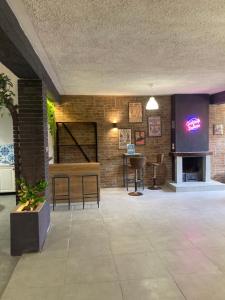 a room with a brick wall and a table and chairs at Loft - Villa Flore apartments in villa in Casteldaccia