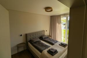 a bedroom with a bed with two towels on it at 313 apartments in Užpelkiai