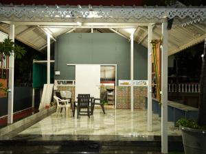a patio with a table and chairs at The Tree Resort in Malavli