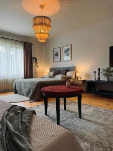 a living room with two beds and a table at The Garden room in Ikšķile