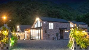 a home at night with lights at Danyang Dandelion Pool Villa in Danyang