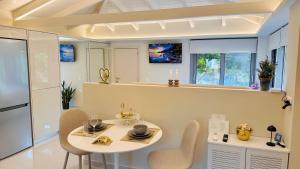 a dining room with a table and chairs in a kitchen at Sunset Suite Mytikas in Mytikas