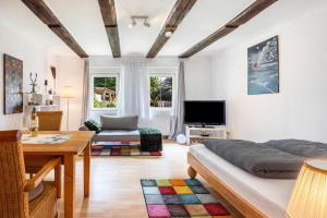a living room with a bed and a table at Fuchsrevier Fox District Apartment in Erkerode