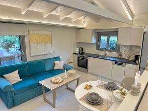 a living room with a blue couch and a table at Sunset Suite Mytikas in Mytikas