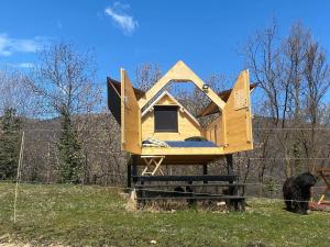 a house shaped like a plane sitting on a fence at Stars box La Barona in Villar San Costanzo