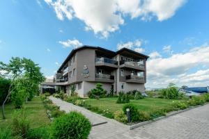 an apartment building with balconies and a lawn at Vital Hotel in Sofia