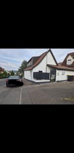 a car parked in front of a white building at Nektarioss in Kernen