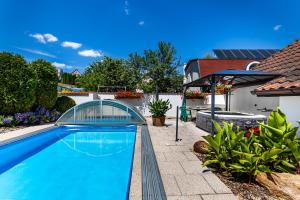 a swimming pool in the backyard of a house at Jaroslav Ambrož Elvomont Chlum u Třeboně in Chlum u Třeboně