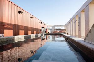 a pool of water between two buildings at JOST Hôtel Bordeaux Centre Gare Saint Jean in Bordeaux