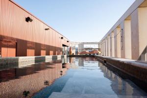a pool of water between two buildings at JOST Hôtel Bordeaux Centre Gare Saint Jean in Bordeaux