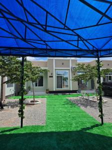 a large blue roof over a yard with green grass at VC Heritage Residences in Dodoma