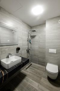 a bathroom with a white sink and a toilet at Vital Hotel in Sofia +81 photos
